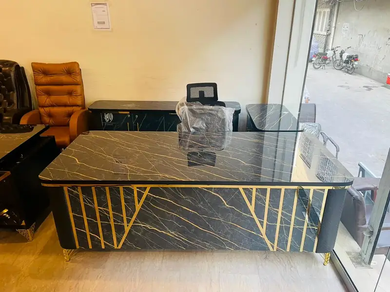 Black marble finish executive table with gold strips in our Lahore showroom
